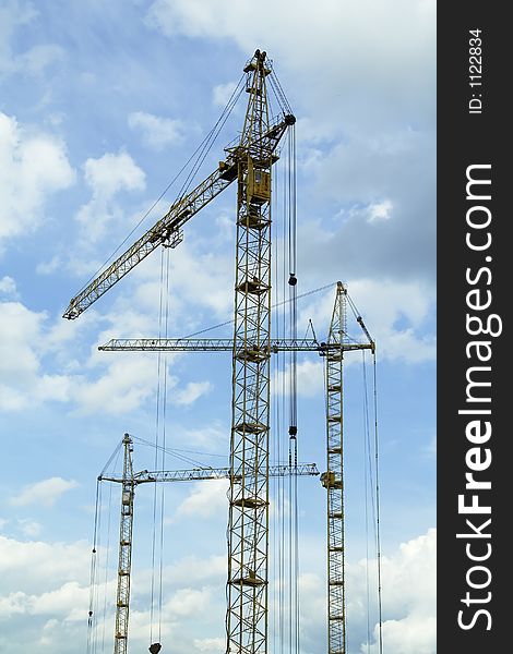 Crane tower on a background of the blue sky