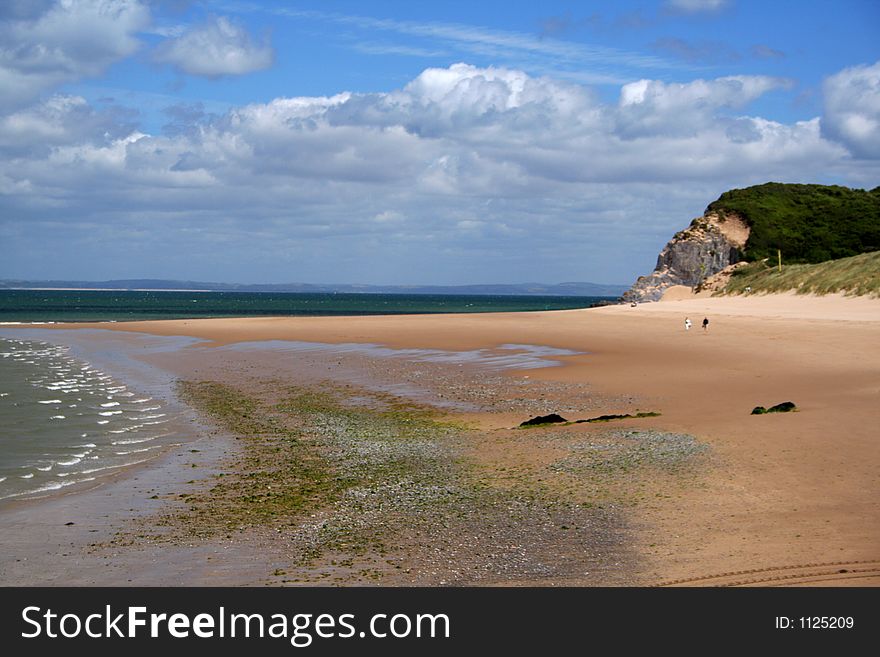 Couple walking along a deserted beach. Couple walking along a deserted beach