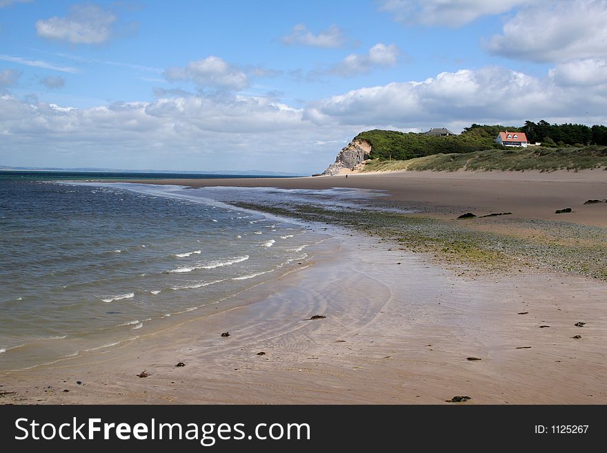 Deserted beach with a house on a hill. Deserted beach with a house on a hill