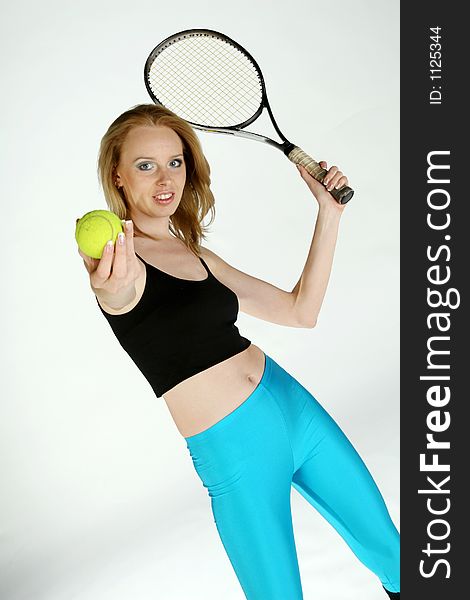 A Girl posing with a tennis racket. A Girl posing with a tennis racket