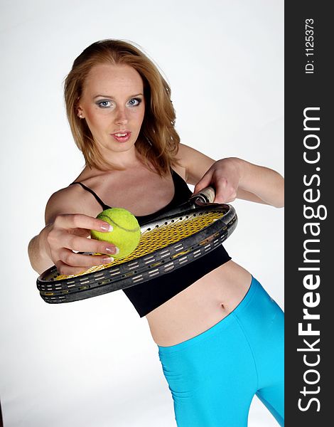A girl holding a tennis racket with ball. A girl holding a tennis racket with ball