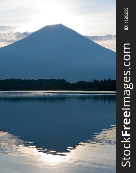 Early morning view of Mount Fuji and its reflection in a nearby lake. Early morning view of Mount Fuji and its reflection in a nearby lake.