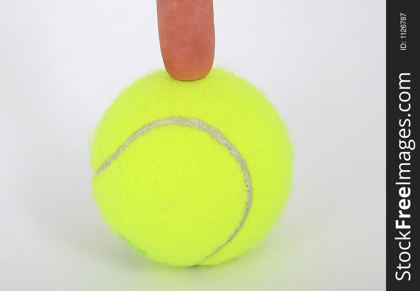 Tennis ball and a finger isolated on white, close-up, copy space, macro,. Tennis ball and a finger isolated on white, close-up, copy space, macro,