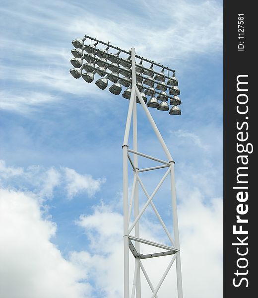 Sports ground floodlight pylon against pale blue sky