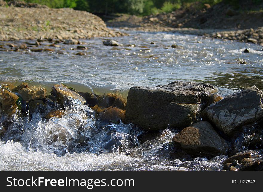 Landscape image at the mountain, with river and little waterfall. Landscape image at the mountain, with river and little waterfall