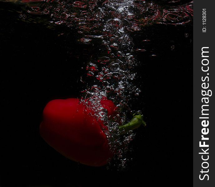 Red fruit falling in the water. Red fruit falling in the water