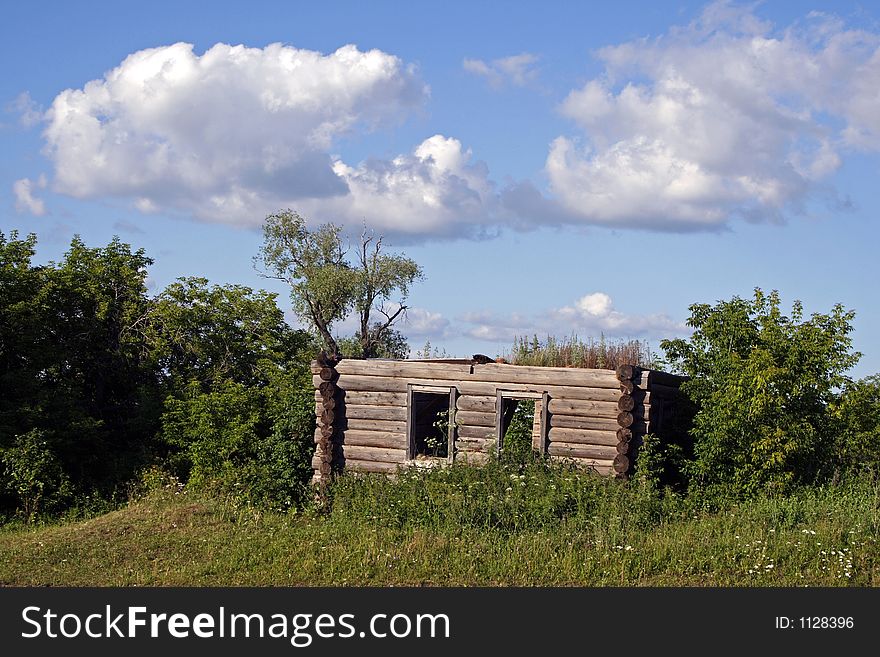 abandoned house on a hill, sourounded by trees