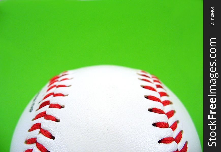 Baseball isolated on green with red stitches detail. Baseball isolated on green with red stitches detail