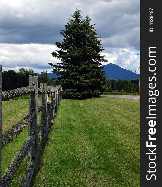 Wooden fence in Adirondack state Park, NY. View on high pekas region. Wooden fence in Adirondack state Park, NY. View on high pekas region