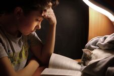 Teenager Boy Make Homework At Desk With Lamp Book Stock Image