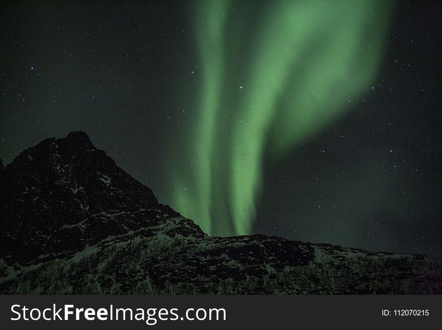 Vertical strong northern Lights beams in Tromso