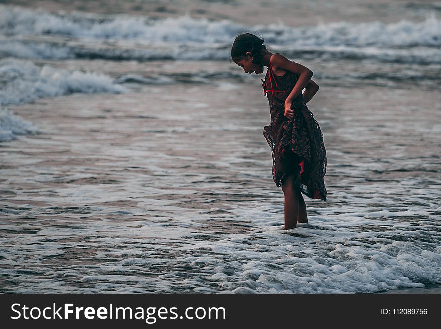 Girl Standing on Seashore