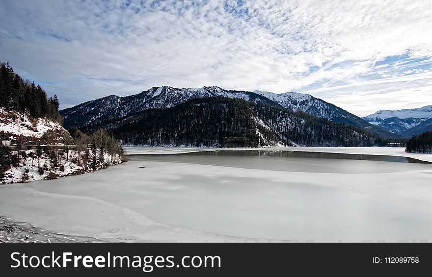 Snow Mountain With White Cloudy Sky