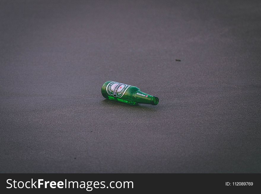Empty Heineken Bottle on Ground