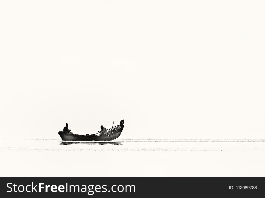 Two Person Riding Boat on Body of Water