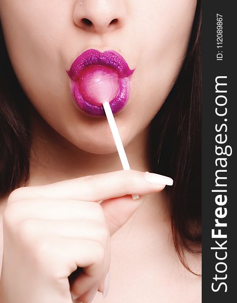 Woman With Pink Lipstick Licking Strawberry Lollipop