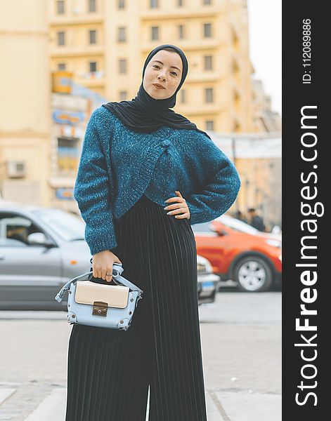 Woman Wears Blue And Black Sweater With Pants