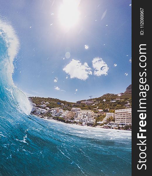 Closeup Photography of Sea Wave Near Concrete Building at Daytime