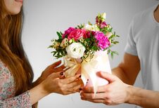 The Guy Gives A Bouquet Of Flowers To A Girl. Composition Of Flo Stock Photography