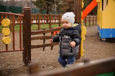 Little Boy Dressed In Warm Clothes Walking On The Playground Stock Image