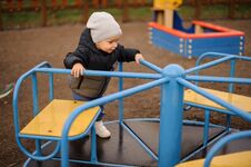 Cute Little Boy Dressed In A Warm Hat And Jacket Riding On The C Royalty Free Stock Image