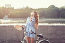 Smiling Woman With A Bicycle Stock Photo