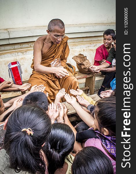 Monk Handing Towards Kids