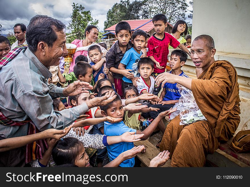 Group Of People Begging On Monk