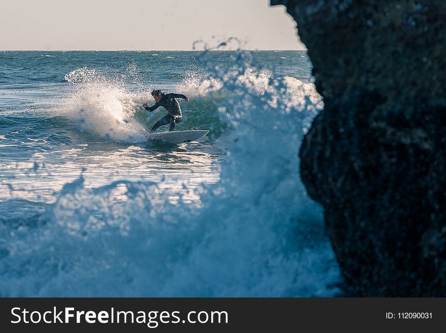 Man Surfing On Body Of Water