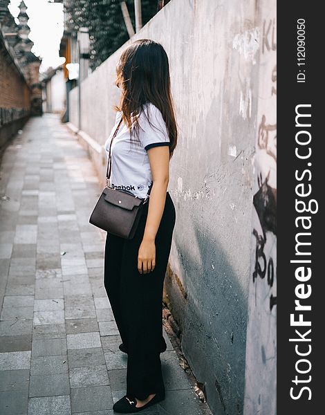 Woman Wearing Black And White T-shirt And Black Pants