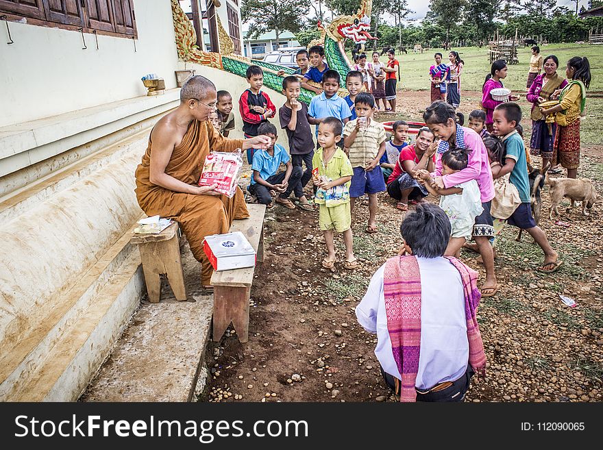 Group of Children in Front of Monk at Daytime
