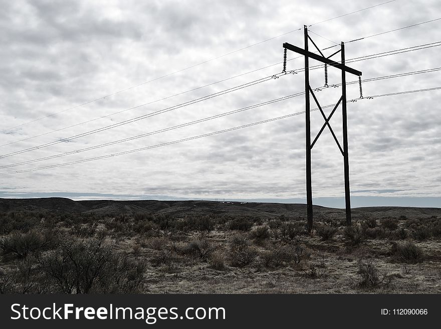 Photograph of Electrical Post on Cloudy Day