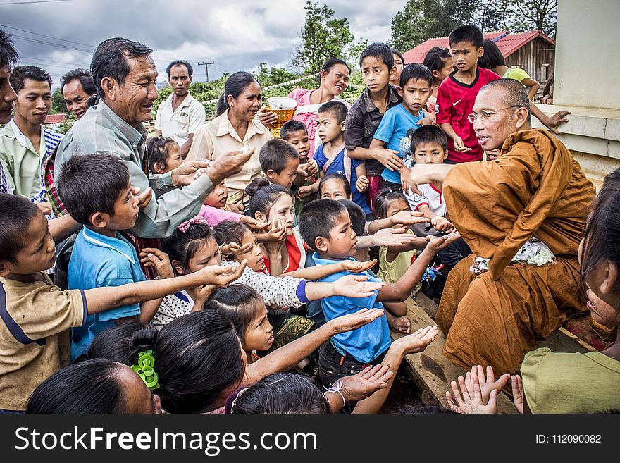 Group of Children Raising Their Palm Towards a Man