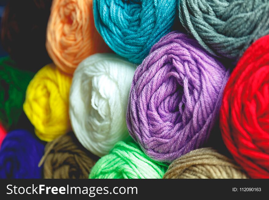 Close up colorful wool detail on wooden table background and concept