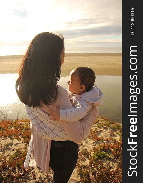 Mom and baby enjoying time on the beach