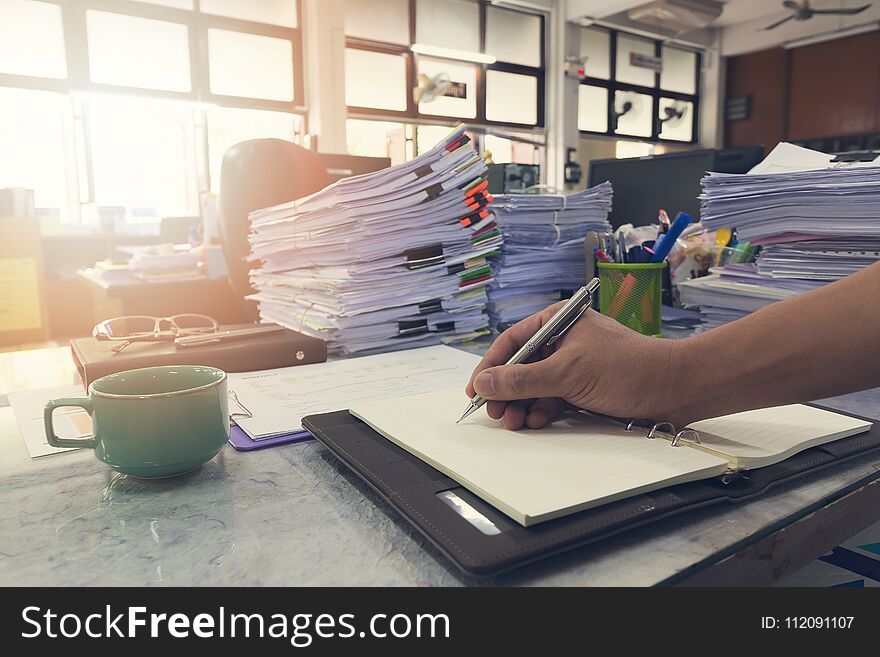 Business and finance concept of office working, Businessman writing reminder on notebook.