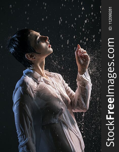 Brunette In Wet Shirt Under Water In The Dark