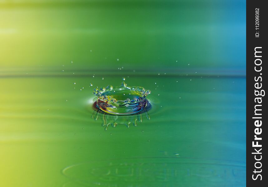 Waterdrop crown with colorful backgroun nikon d7100 18-105 lens close up. Waterdrop crown with colorful backgroun nikon d7100 18-105 lens close up