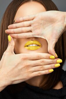 Woman Face. Yellow Nail. Blue Lips. Stock Photography