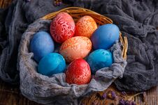 Wicker Basket With Unusual Colored Easter Eggs In Different Colors. Stock Image