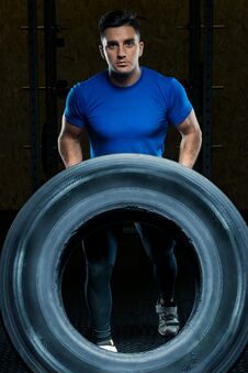 Portrait Of A Strong Athlete With A Large Heavy Wheel Royalty Free Stock Images