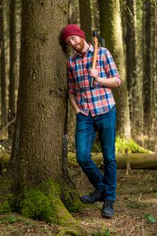 Free Tired Bearded Lumberjack With An Ax Resting, Leaning Against A T Royalty Free Stock Photos - 112105918