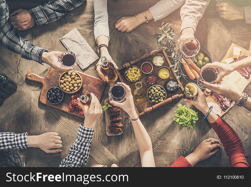 Group Of People Having Meal Togetherness Dining Toasting Glasses