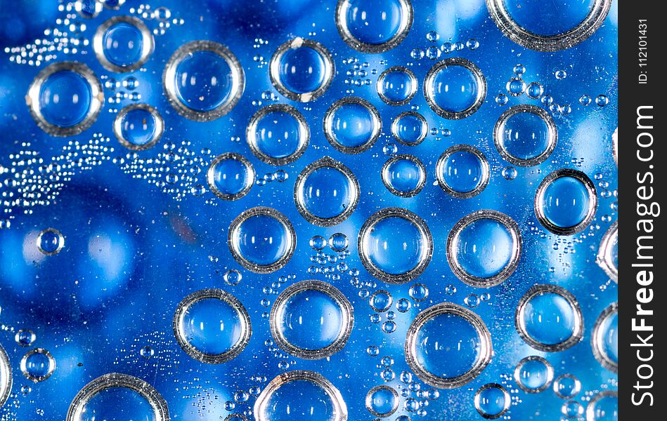 Drops of water on a blue background .