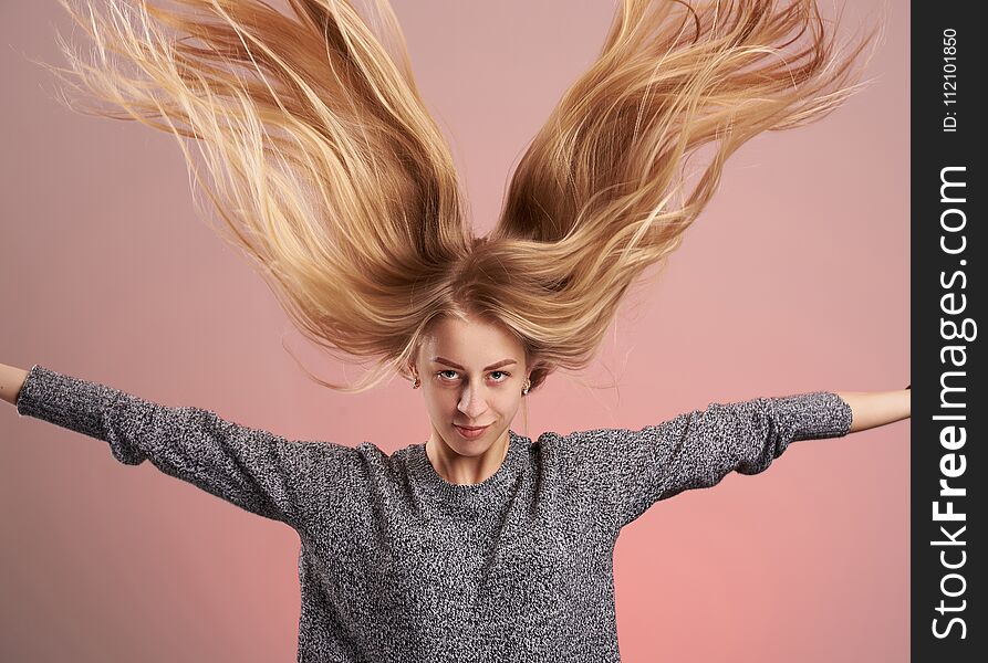 Young blonde woman with hair up isolated on pink background. Young blonde woman with hair up isolated on pink background