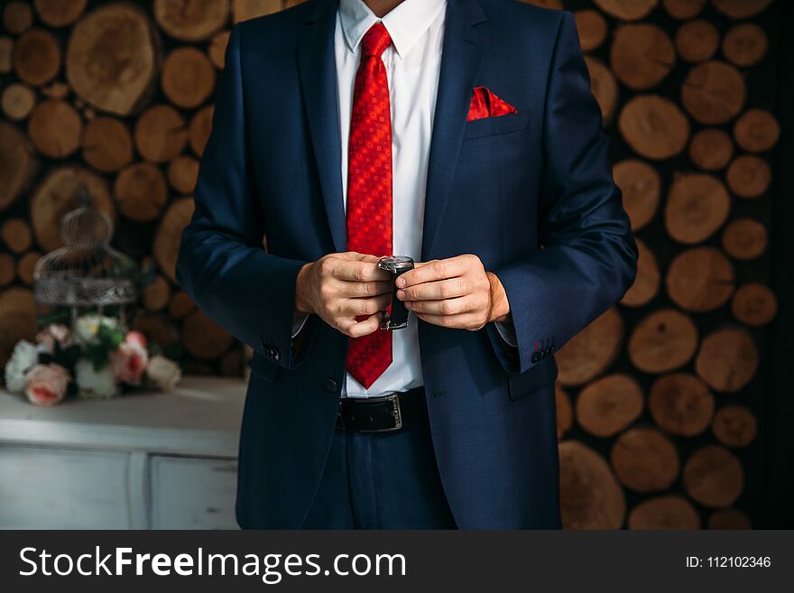 Businessman checking time on his wristwatch. men`s hand with a watch.