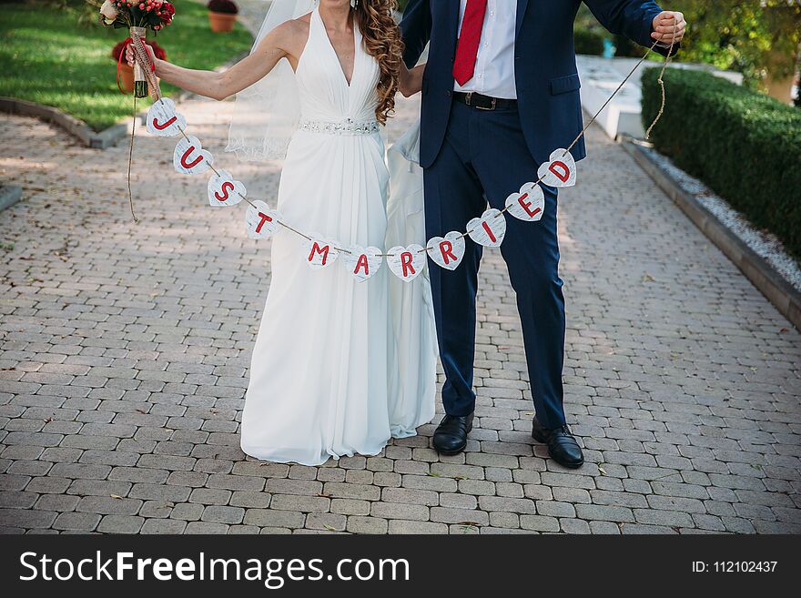 Beautiful Wedding Inscription Just Married. Close-up Beauty Placard. Bridal And Groom Accessories. Details For Marriage