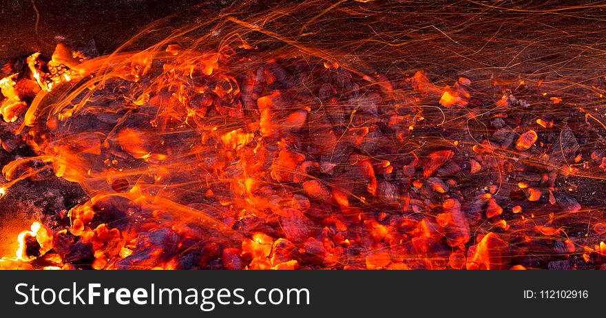 Burning charcoal as background . Photo of an abstract texture