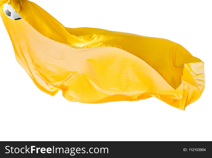 Soccer ball and Smooth elegant transparent yellow cloth isolated or separated on white studio background. Texture of flying fabric. yellow. Attributes of popular game. Concept of national flag color