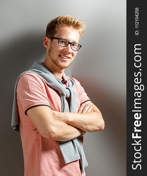 Handsome young blonde man on grey background. Handsome young blonde man on grey background.